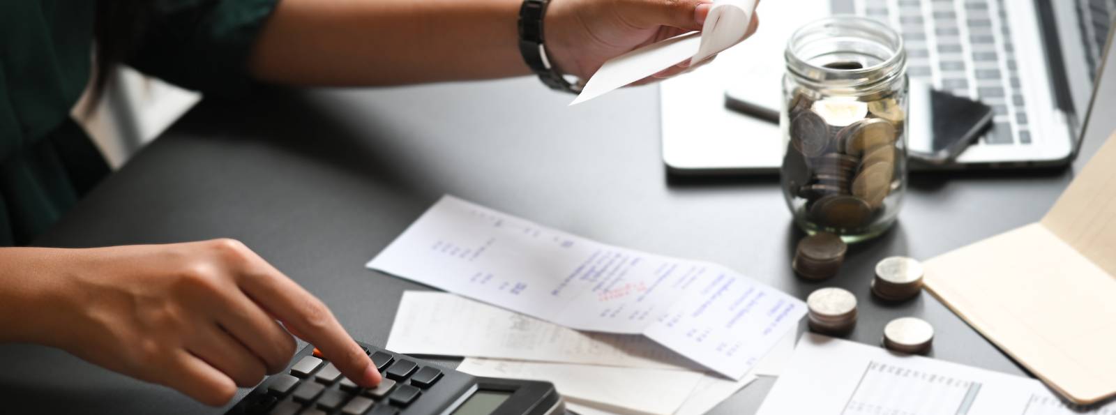 woman typing receipt values into a calculator